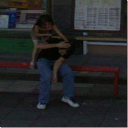 Little sister beating up her bigger brother at a bus stop