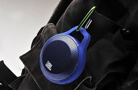 JBL Clip bluetooth speaker clipped onto a backpack