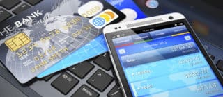 mobile banking - picture of phone, cards, and laptop