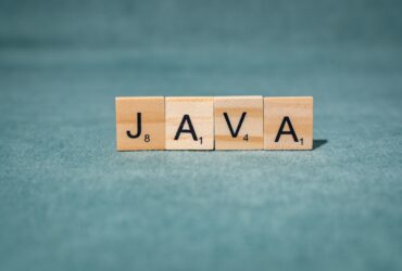 scrabble letters spelling java on teal background