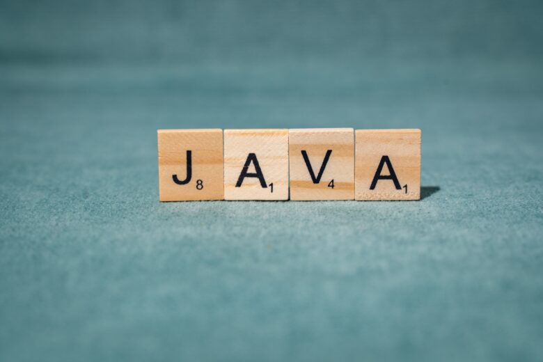 scrabble letters spelling java on teal background