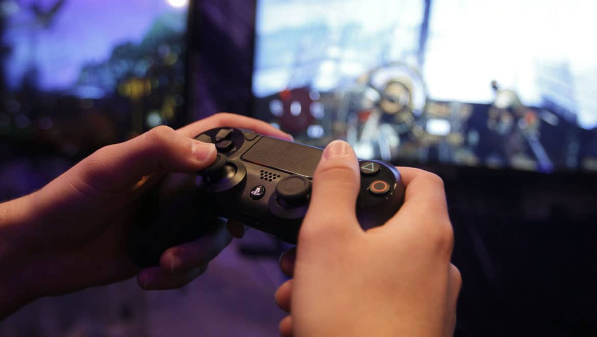 player holding a gaming console controller