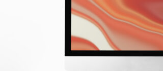 computer desktop screen on table with orange screensaver