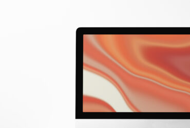computer desktop screen on table with orange screensaver