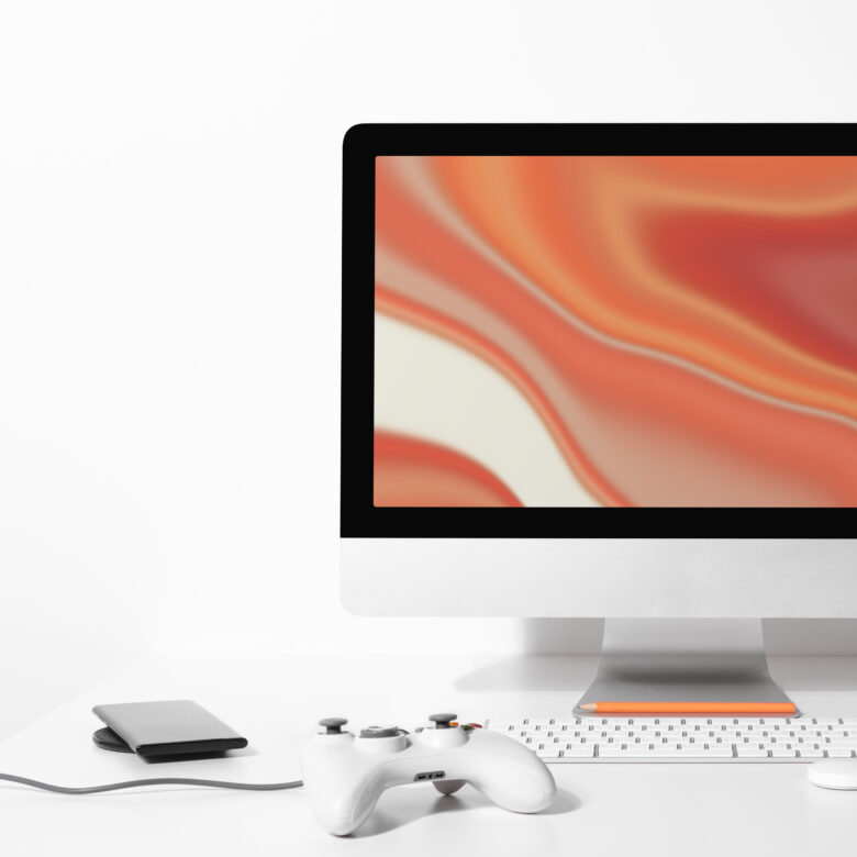 computer desktop screen on table with orange screensaver