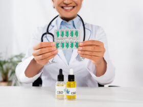 doctor holding pills with cbd oils in front of her
