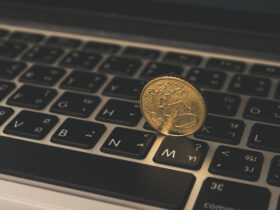 gold coin on laptop keyboard