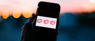 phone with comment, like, and followers buttons