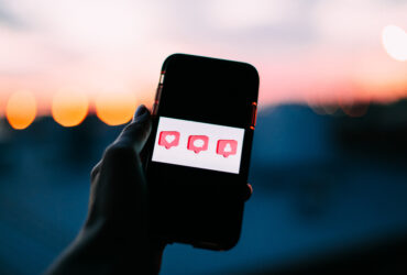 phone with comment, like, and followers buttons
