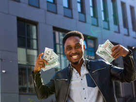 Happy entrepreneur with handfuls of money