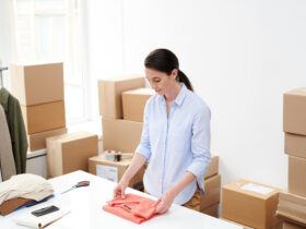 young woman packing orders for online shop