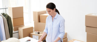 young woman packing orders for online shop