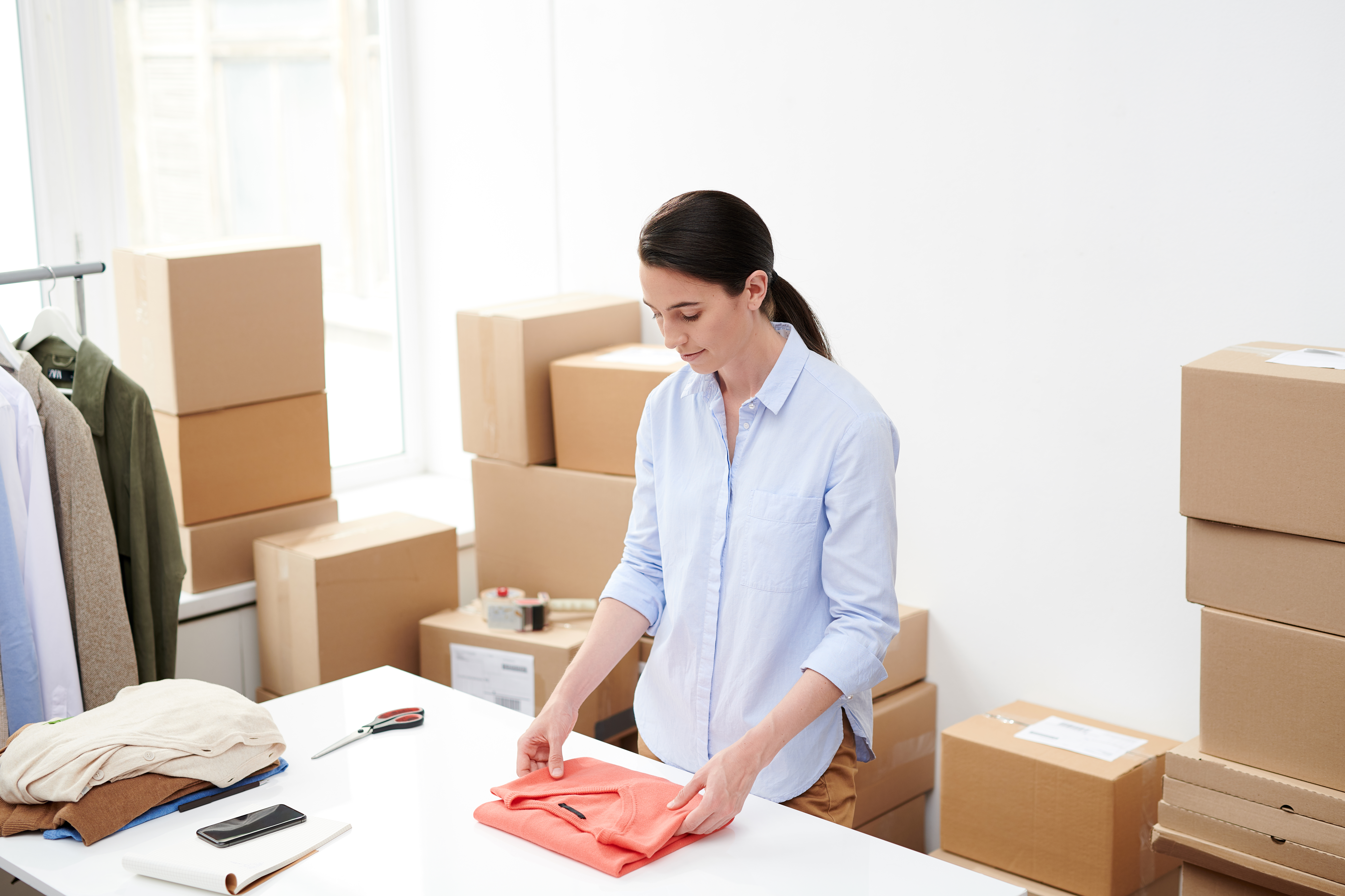 young woman packing orders for online shop