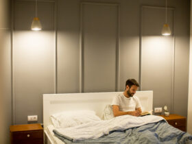 man in minimalist bedroom with lighting