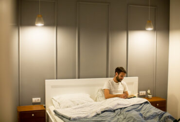 man in minimalist bedroom with lighting