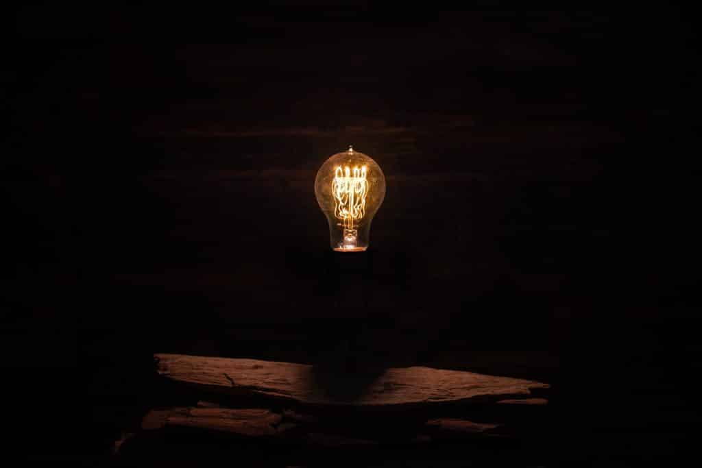 light bulb lit in a dark room