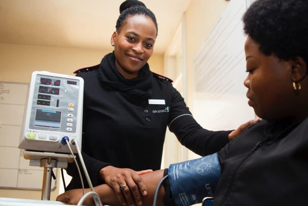 A paramedic taking a woman's blood pressure