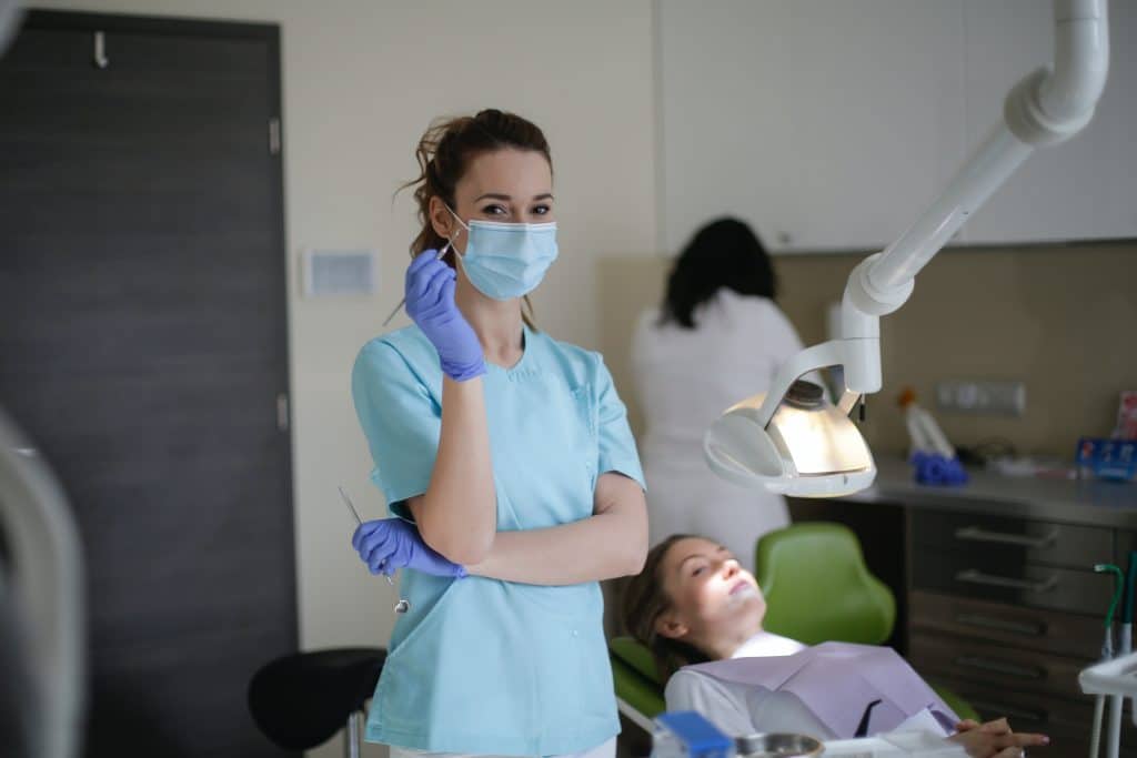 nurse standing over patient