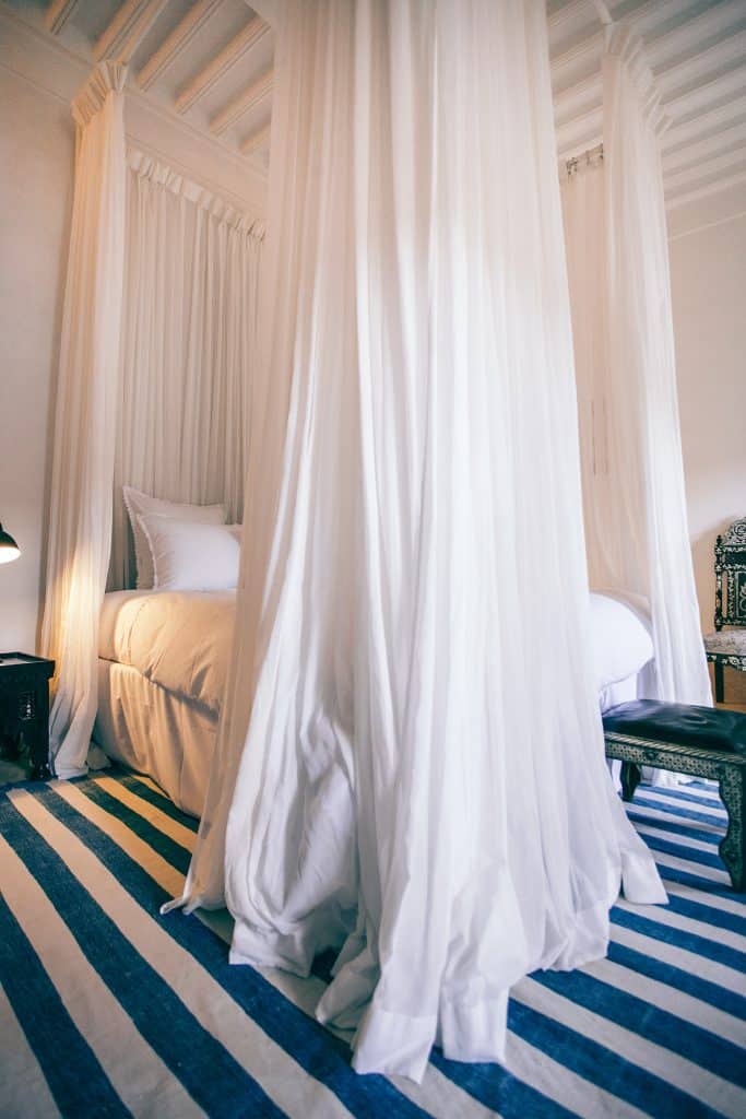 Large bed with curtains hanging around it