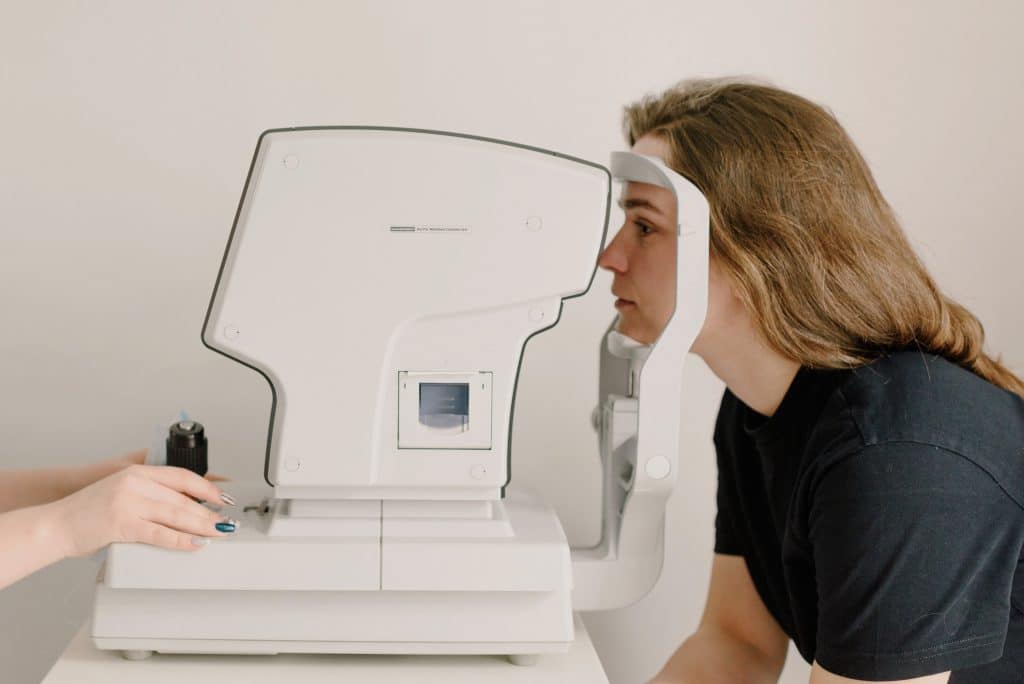 a woman getting her eyes checked with a machine