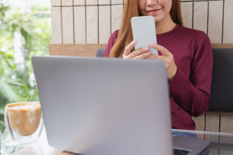 young woman holding and using smart phone