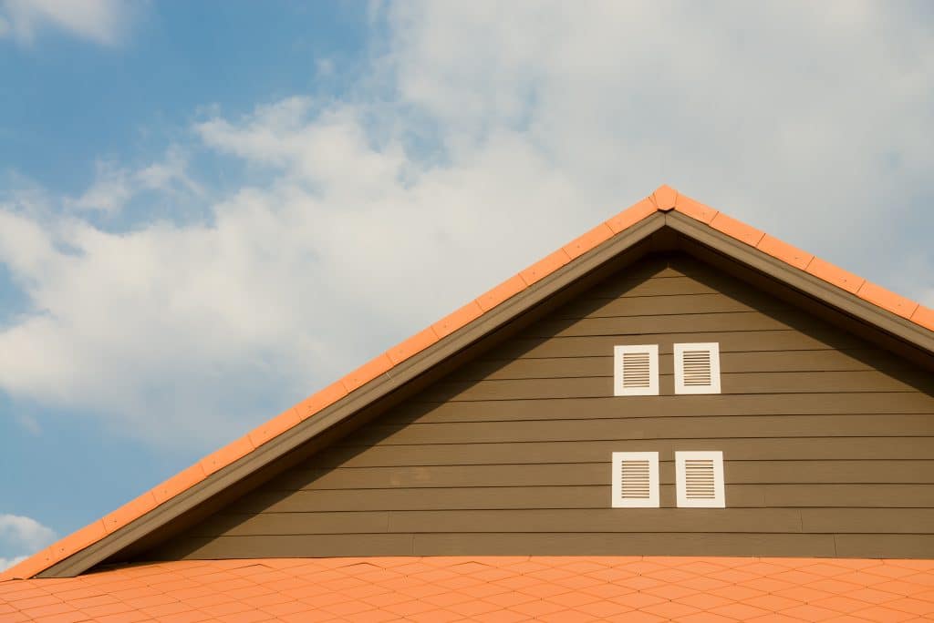 brown house with orange specialty roofing