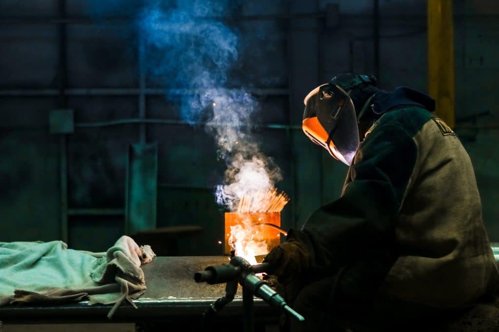 man welding on a workbench