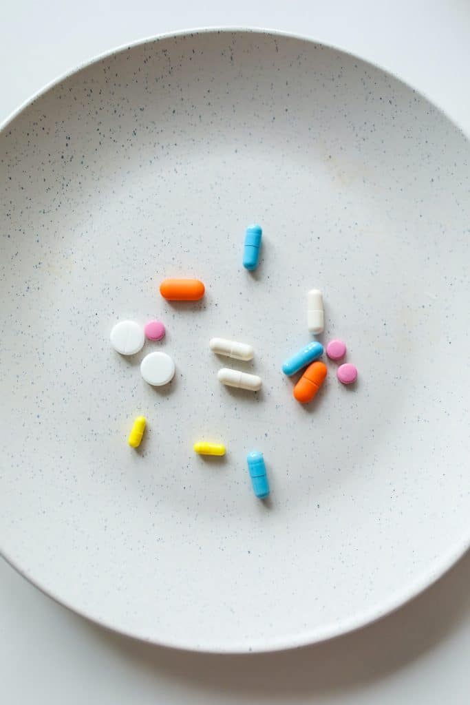 a variety of pills on a white plate