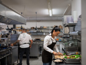 female chef cutting vegetables in kitchen