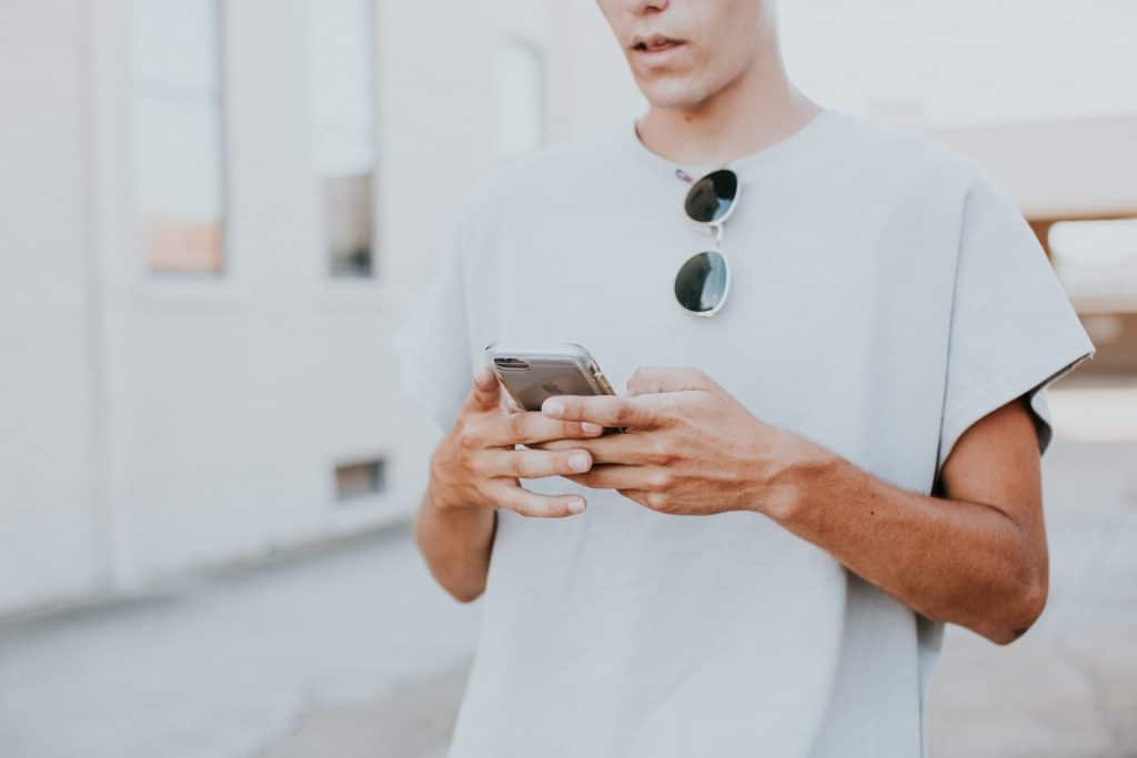 man scrolling on his phone