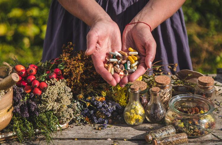 Woman holding herbal supplements