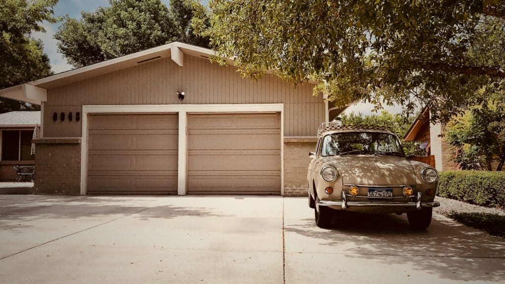 car parked in front of a two-car garage