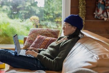 woman on couch working from home