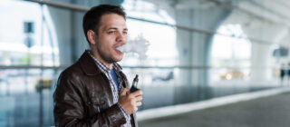 Man using e cigarette vaporizer