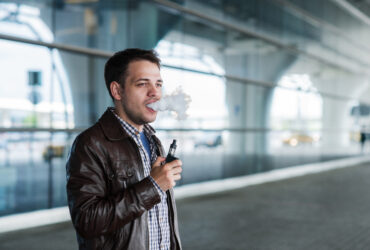 Man using e cigarette vaporizer