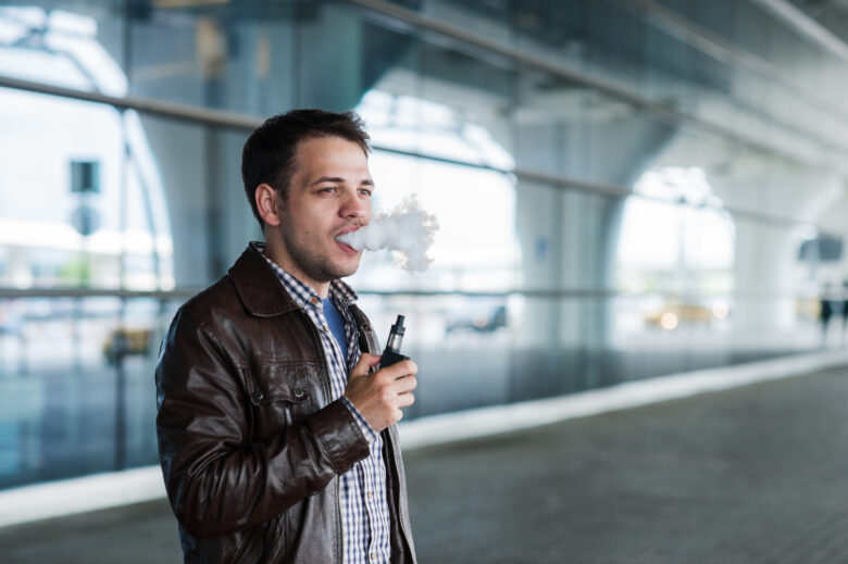 Man using e cigarette vaporizer