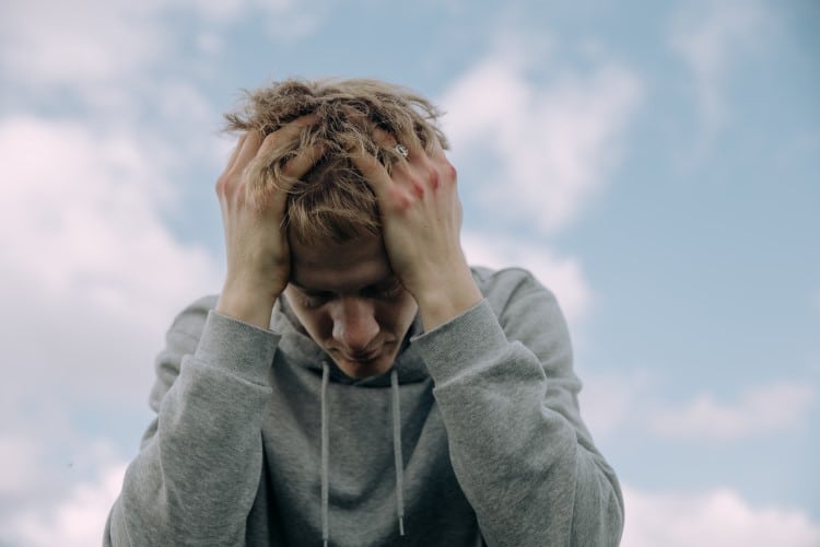 man with head in his hands