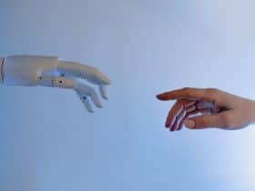 robot and human hand reaching out to each other