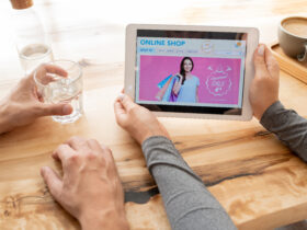 young woman holding tablet with online shop