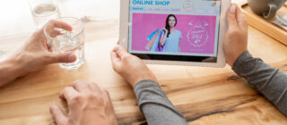 young woman holding tablet with online shop