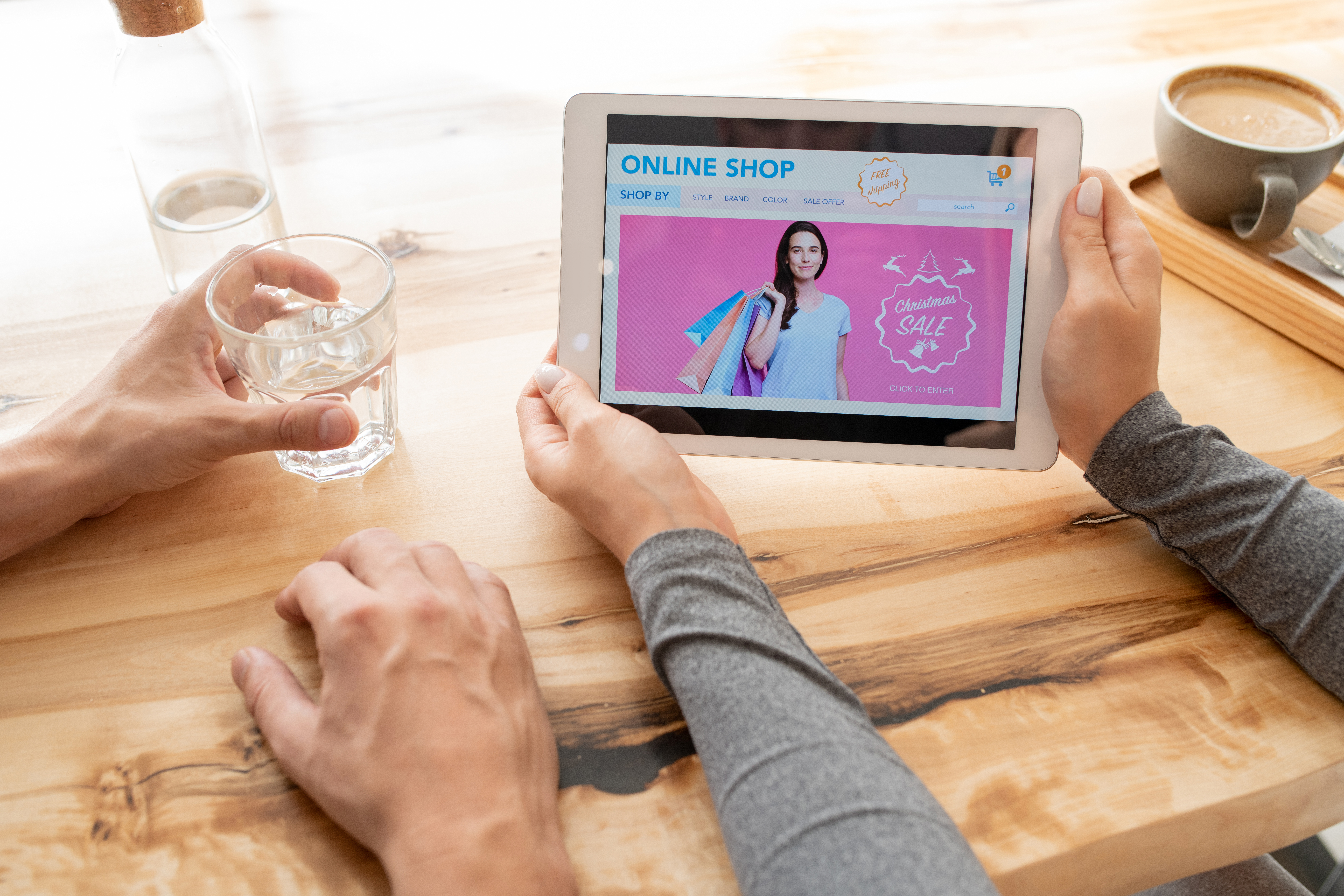 young woman holding tablet with online shop