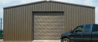 large steel garage with truck in front