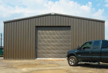 large steel garage with truck in front