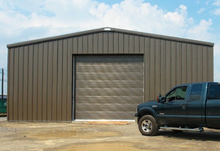 large steel garage with truck in front