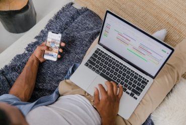 looking down at man with laptop and phone