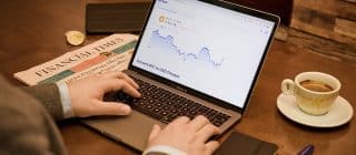 man investing on laptop