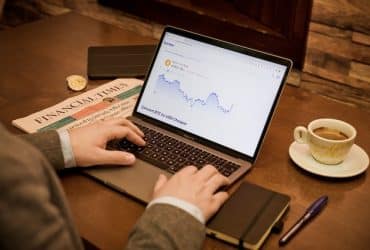 man investing on laptop