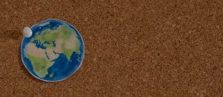picture of earth posted on a cork board