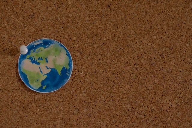 picture of earth posted on a cork board