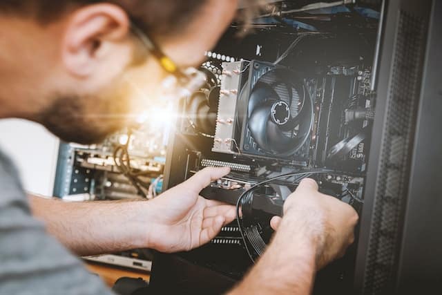 man repairing a PC